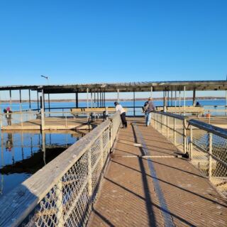 This Oklahoma Lake Has a Big Fishing Dock With Benches Where Anglers Keep Reeling Them In