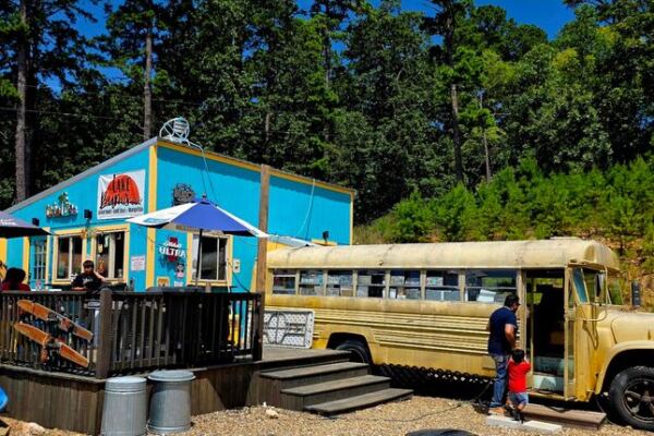 This Oklahoma Bar & Grill Near Broken Bow Serves Big Burgers And Cheesesteaks Inside An Old School Bus