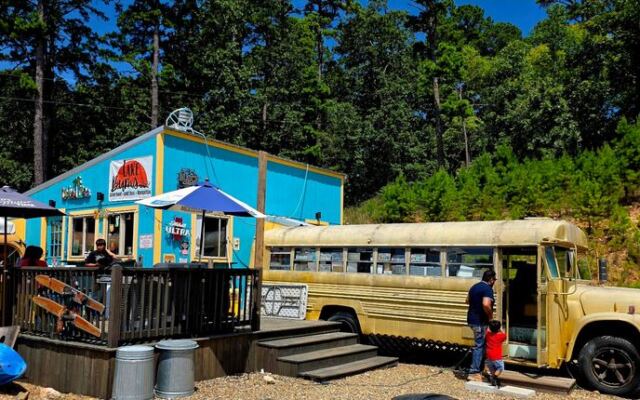 This Oklahoma Bar & Grill Near Broken Bow Serves Big Burgers And Cheesesteaks Inside An Old School Bus