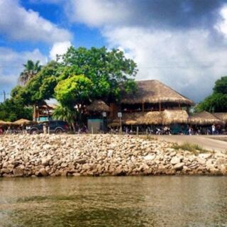 This Texas Hangout Serves Grilled Oysters Under Tiki Huts on Galveston Bay, With Weekend Live Music