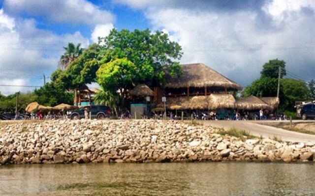 This Texas Hangout Serves Grilled Oysters Under Tiki Huts on Galveston Bay, With Weekend Live Music