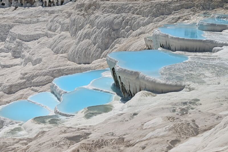 Warm Blue Pools Spill Across Snow-White Terraces at This Extraordinary Turkish Site