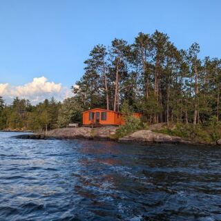 This Northwoods Minnesota Lodge Still Rents Log Cabins From the 1920s on a Crystal-Clear Lake