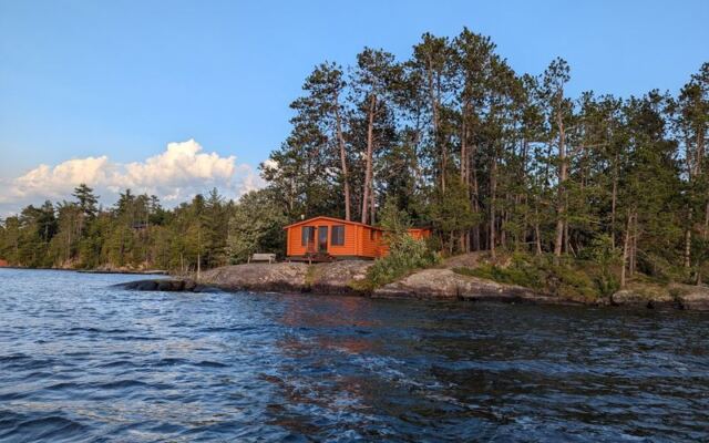 This Northwoods Minnesota Lodge Still Rents Log Cabins From the 1920s on a Crystal-Clear Lake