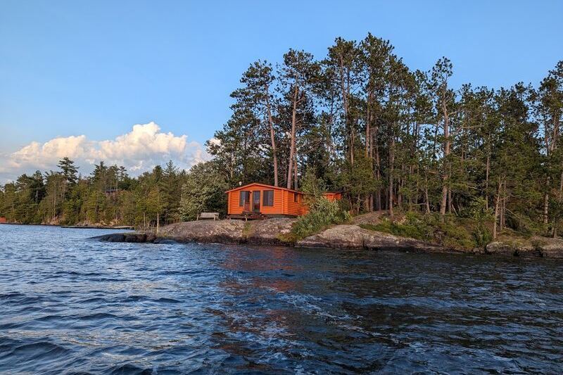 This Northwoods Minnesota Lodge Still Rents Log Cabins From the 1920s on a Crystal-Clear Lake